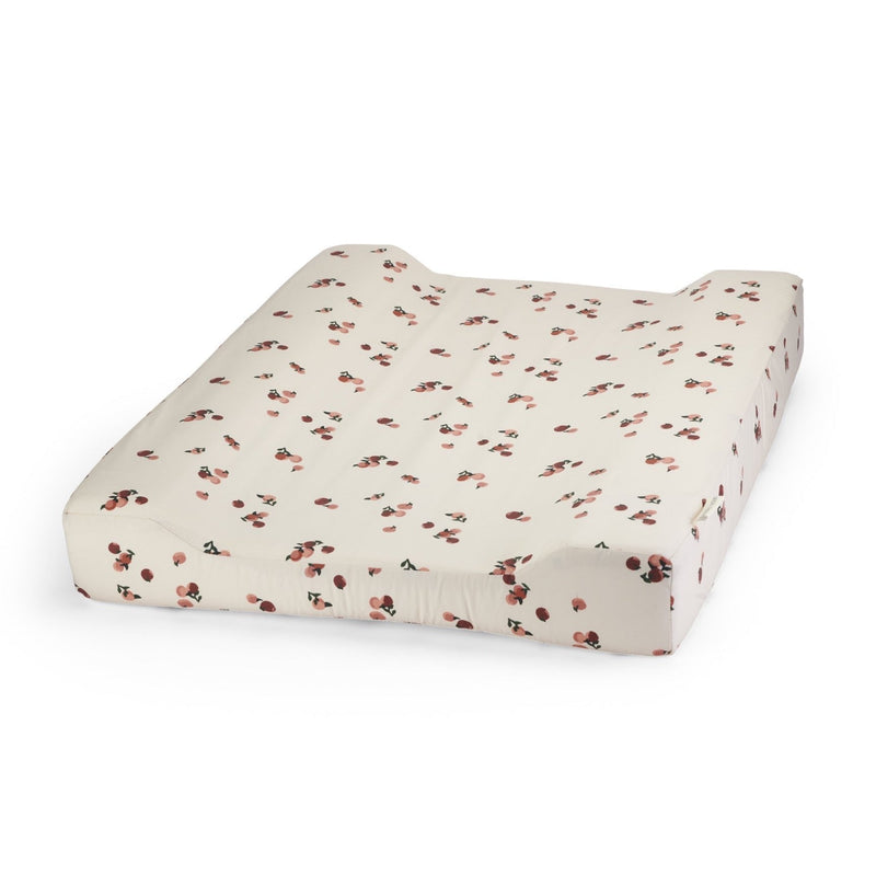 Padded baby changing mat with removable cotton cover in a pretty peaches print