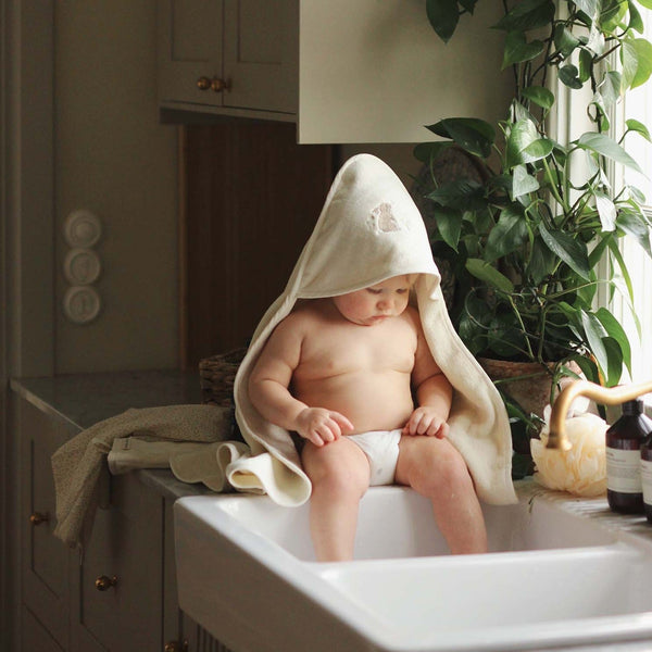 Organic cotton hooded baby towel with an embroidered bunny on the hood