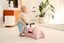 Baby with push along baby walker by scoot and ride