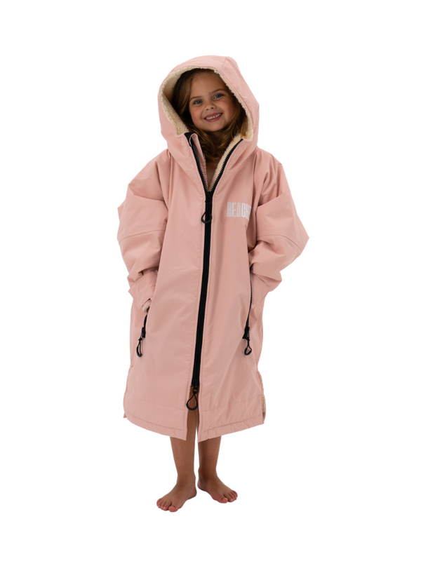 Kids waterproof changing robe in baby pink with a sherpa lining and chunky zip front.