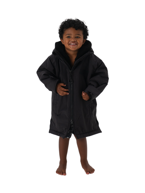 A kids waterproof changing robe with sherpa lining in a charcoal grey colour.