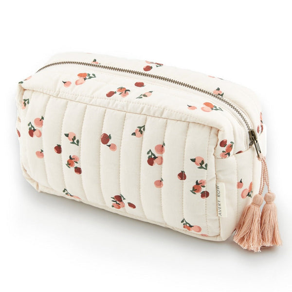 A quilted wash bag in a peaches print with zip top and tassle