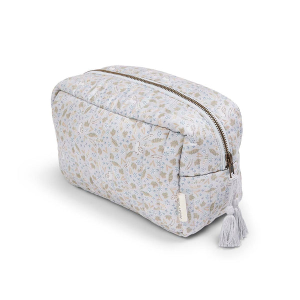 A quilted washbag in a mini floral print with a zip top and tassle